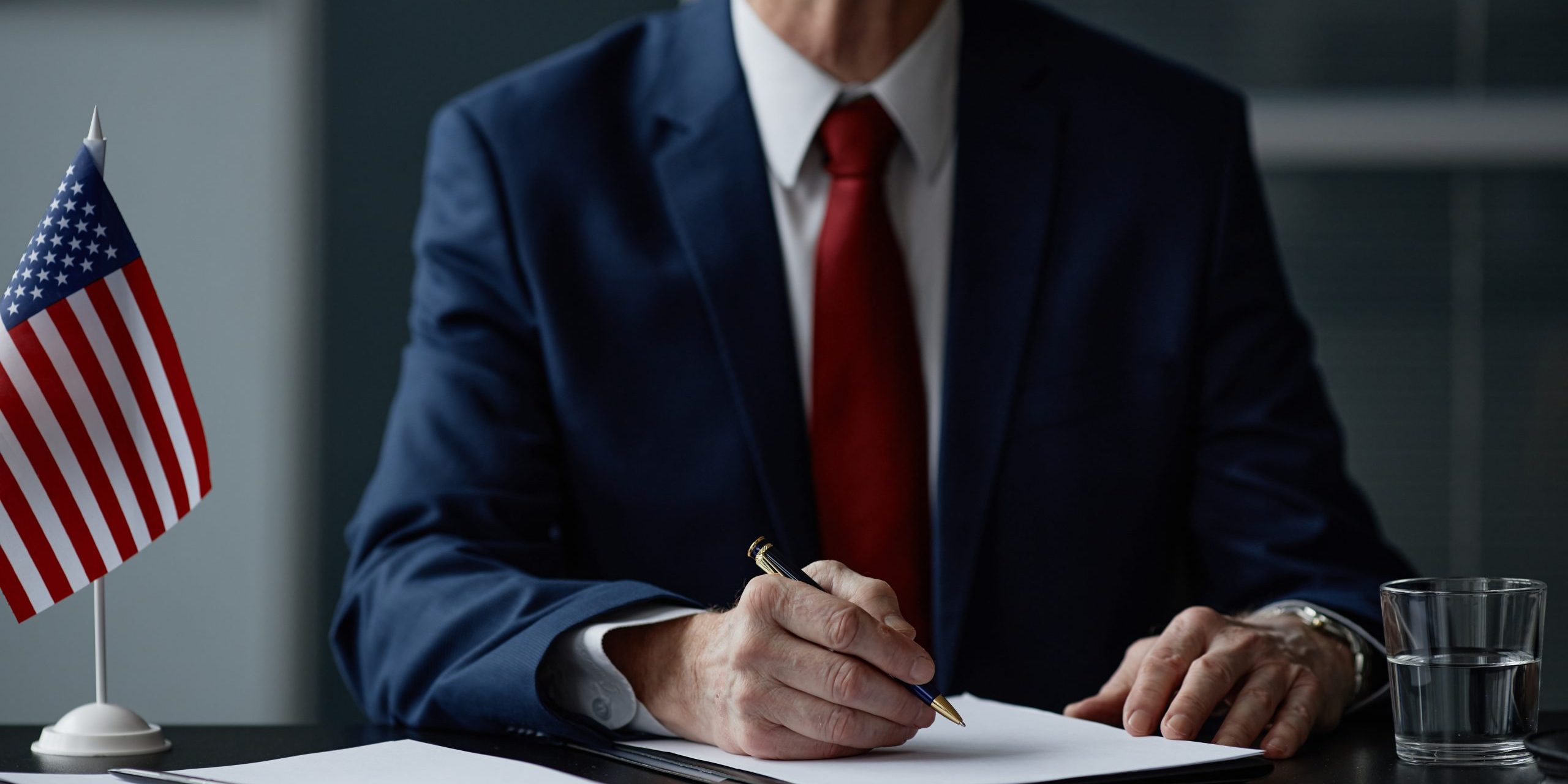 Caucasian Senior Male Politician Signing Documents during Business Meeting